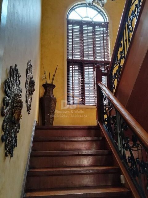 Real wood blinds on a staircase window in Makati